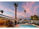 Inviting outdoor pool and deck with lounge chairs and umbrella at dusk at 2923 N 81St Pl, Scottsdale, AZ 85251