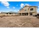 Spacious backyard with plenty of space for outdoor activities and entertaining, with the home in background at 3022 N Lainey Ln, Buckeye, AZ 85396