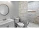 Modern bathroom featuring stylish vanity with sink and stunning tiled walk-in shower at 3022 N Lainey Ln, Buckeye, AZ 85396