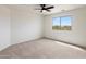 Bright bedroom with neutral carpet, ample natural light, and views of the neighborhood at 3022 N Lainey Ln, Buckeye, AZ 85396