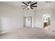 Spacious carpeted bedroom features a ceiling fan and convenient ensuite bathroom access at 3022 N Lainey Ln, Buckeye, AZ 85396