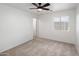 Light-filled carpeted bedroom includes a ceiling fan and bright window at 3022 N Lainey Ln, Buckeye, AZ 85396