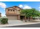 Charming two-story home with desert landscaping, a two-car garage, and a welcoming front porch at 3022 N Lainey Ln, Buckeye, AZ 85396