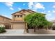 Inviting exterior of a two-story home with a well-manicured front yard and attached two-car garage at 3022 N Lainey Ln, Buckeye, AZ 85396