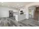 Open-concept kitchen with white cabinetry, stainless steel appliances, and a breakfast bar at 3022 N Lainey Ln, Buckeye, AZ 85396