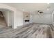 Open concept living room featuring a fireplace, wood-look flooring and recessed lights at 3022 N Lainey Ln, Buckeye, AZ 85396