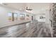 Bright and airy living room featuring wood-look floors, a fireplace, and an open layout at 3022 N Lainey Ln, Buckeye, AZ 85396