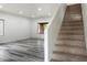 Bright living room features wood-style floors, recessed lighting, and staircase access at 3022 N Lainey Ln, Buckeye, AZ 85396