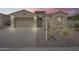 Charming single-story home with a well-manicured front yard and a brick-paved driveway leading to an attached garage at 32366 N 133Rd Ln, Peoria, AZ 85383