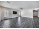 Spacious living room with tile floors, ceiling fan, and recessed lighting at 32366 N 133Rd Ln, Peoria, AZ 85383