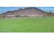 Large, green open field with scenic mountain views in the background, perfect for outdoor activities at 32366 N 133Rd Ln, Peoria, AZ 85383
