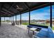 Spacious covered patio with comfortable seating, offering views of the pool and surrounding landscape at 32366 N 133Rd Ln, Peoria, AZ 85383