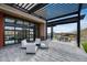 Inviting outdoor seating area with modern furniture and a pergola overlooking scenic community amenities at 32366 N 133Rd Ln, Peoria, AZ 85383