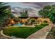 Backyard featuring a lush lawn, patio area, lounge chairs, and a gazebo at 3628 E Meadowview Dr, Gilbert, AZ 85298