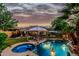 Serene backyard oasis featuring a sparkling pool, spa, gazebo, and lush landscaping at 3628 E Meadowview Dr, Gilbert, AZ 85298
