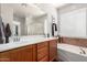 Elegant bathroom features double sinks, a large mirror, a soaking tub, and a separate shower at 3628 E Meadowview Dr, Gilbert, AZ 85298