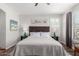 Cozy bedroom features a plush bed, end tables with lamps, and natural light from the window at 3628 E Meadowview Dr, Gilbert, AZ 85298