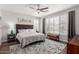 Inviting main bedroom features large windows, shutters, and a plush bed with decorative pillows at 3628 E Meadowview Dr, Gilbert, AZ 85298
