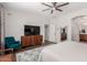 Spacious bedroom offers wood floors, a flat-screen TV, and a large window for plenty of natural light at 3628 E Meadowview Dr, Gilbert, AZ 85298