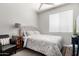 Charming bedroom with a comfortable bed, side table with lamp, and a cozy chair at 3628 E Meadowview Dr, Gilbert, AZ 85298