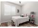 Cozy bedroom featuring wood flooring, a bright window, and neutral decor at 3628 E Meadowview Dr, Gilbert, AZ 85298