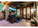 Cozy covered patio with comfortable seating, a ceiling fan, and a view into the home's interior at 3628 E Meadowview Dr, Gilbert, AZ 85298