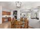 Bright dining area with a glass table, wooden chairs, and views to the living room and back yard at 3628 E Meadowview Dr, Gilbert, AZ 85298