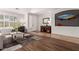 Bright living room featuring wood floors, large windows, and stylish decor at 3628 E Meadowview Dr, Gilbert, AZ 85298