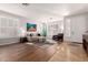Bright living room featuring wood floors, large windows, and stylish decor at 3628 E Meadowview Dr, Gilbert, AZ 85298