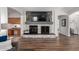 Cozy living room with a stone fireplace, hardwood floors, and modern decor at 3628 E Meadowview Dr, Gilbert, AZ 85298