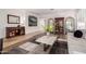 Bright living room featuring wood floors, large windows, and stylish decor at 3628 E Meadowview Dr, Gilbert, AZ 85298