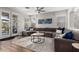 Bright living room with French doors, a large sectional sofa, and a neutral-toned rug at 3628 E Meadowview Dr, Gilbert, AZ 85298