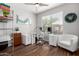 Bright home office with dark wood floors, a white desk, and modern decor at 3628 E Meadowview Dr, Gilbert, AZ 85298