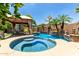 Backyard oasis featuring a sparkling pool, spa, water features, and covered patio area at 3628 E Meadowview Dr, Gilbert, AZ 85298