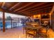 Covered patio and dining set next to a heated pool with an attached stair case in the background at 36801 N Long Rifle Rd, Carefree, AZ 85377