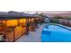 Sparkling in-ground swimming pool with cool decking, outdoor dining, play area, and desert views at 36801 N Long Rifle Rd, Carefree, AZ 85377