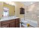 Bright bathroom featuring a vanity with dark wood cabinetry, a tiled shower, and ample counter space at 36801 N Long Rifle Rd, Carefree, AZ 85377