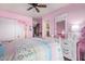 This vibrant pink bedroom features a ceiling fan, a queen bed, and white furniture at 36801 N Long Rifle Rd, Carefree, AZ 85377