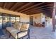 Inviting covered patio area with comfortable seating and outdoor cooking space at 36801 N Long Rifle Rd, Carefree, AZ 85377