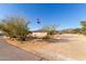 Home with desert landscaping, Arizona flag, and large drive at 36801 N Long Rifle Rd, Carefree, AZ 85377