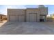 Four-car garage and separate entry door enhances curb appeal with ample vehicle parking at 36801 N Long Rifle Rd, Carefree, AZ 85377