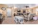 Spacious living room featuring wood-look tile floors, a large TV, and comfortable seating for relaxation and entertainment at 36801 N Long Rifle Rd, Carefree, AZ 85377
