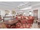 Spacious living room with beamed ceilings, fireplace, and stylish leather furniture at 36801 N Long Rifle Rd, Carefree, AZ 85377