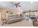 Bright and open living space with wood-look floors, comfortable couch, and seamless flow to the outdoor patio at 36801 N Long Rifle Rd, Carefree, AZ 85377