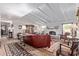 Bright and airy living room featuring a fireplace, piano, and ample seating at 36801 N Long Rifle Rd, Carefree, AZ 85377