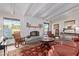 Comfortable living room with fireplace, large windows, and stylish decor at 36801 N Long Rifle Rd, Carefree, AZ 85377