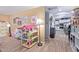 Bright living area with hardwood floors, dollhouse, and easy access to the kitchen showcasing an open floor plan at 36801 N Long Rifle Rd, Carefree, AZ 85377
