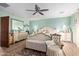 Airy bedroom featuring light green walls, a ceiling fan, and decorative vintage-style furniture at 36801 N Long Rifle Rd, Carefree, AZ 85377