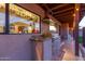 Covered outdoor kitchen area featuring granite countertop, stainless steel grill, and window at 36801 N Long Rifle Rd, Carefree, AZ 85377