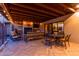 Inviting covered patio featuring a fireplace, comfortable seating, and dining area with string lights at 36801 N Long Rifle Rd, Carefree, AZ 85377